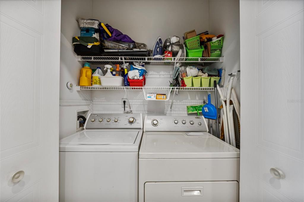 7641 Sailwinds Pass Port Richey, FL 34668 - Photo 33 of 59 a utility room with dryer washer and shoe rack