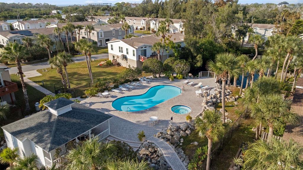 7641 Sailwinds Pass Port Richey, FL 34668 - Photo 47 of 59 an aerial view of a house with a swimming pool and mountains