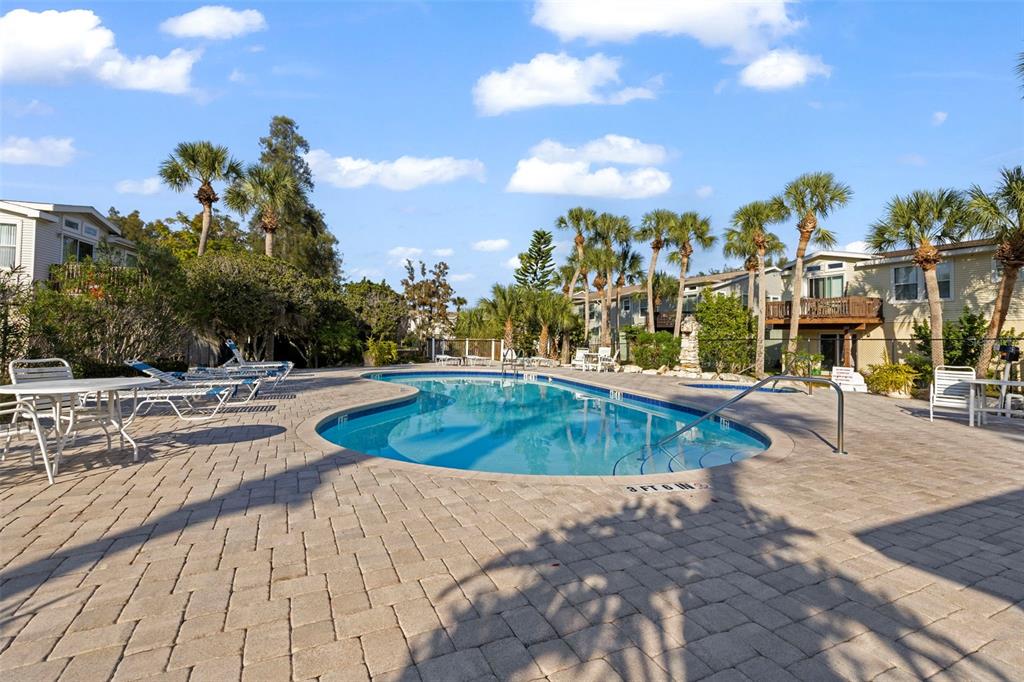 7641 Sailwinds Pass Port Richey, FL 34668 - Photo 52 of 59 a view of a swimming pool with a lounge chairs