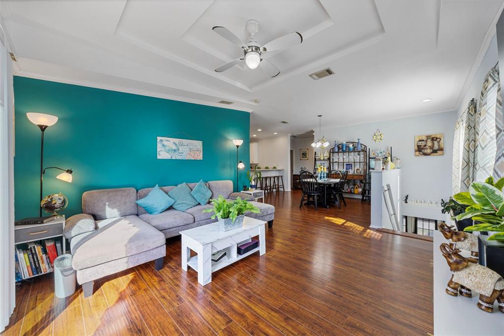 7641 Sailwinds Pass Port Richey, FL 34668 - Photo 9 of 59 a living room with furniture and a wooden floor