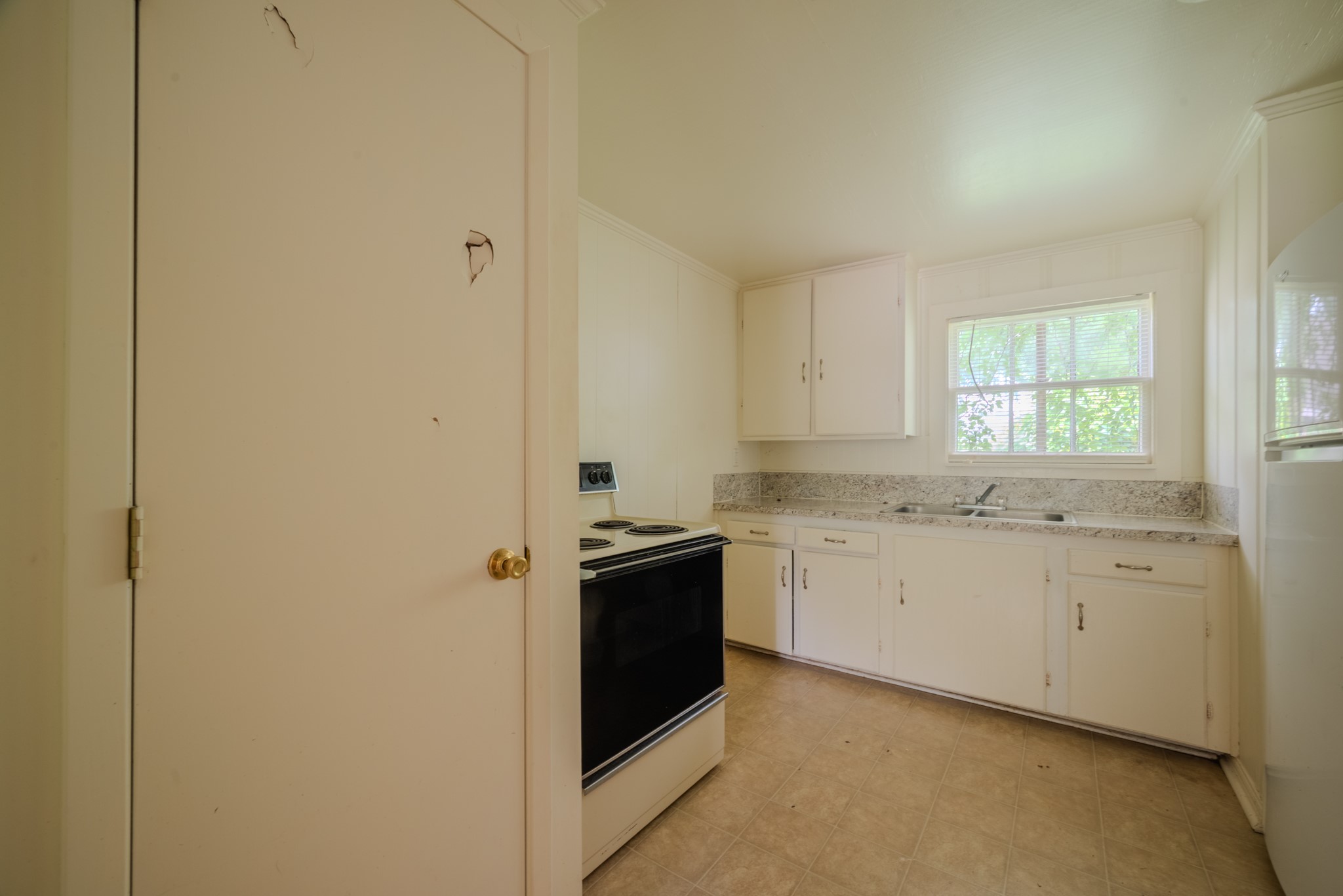 1005 Center Street Wharton, TX 77488 - Photo 11 of 33 a kitchen with granite countertop a sink and cabinets