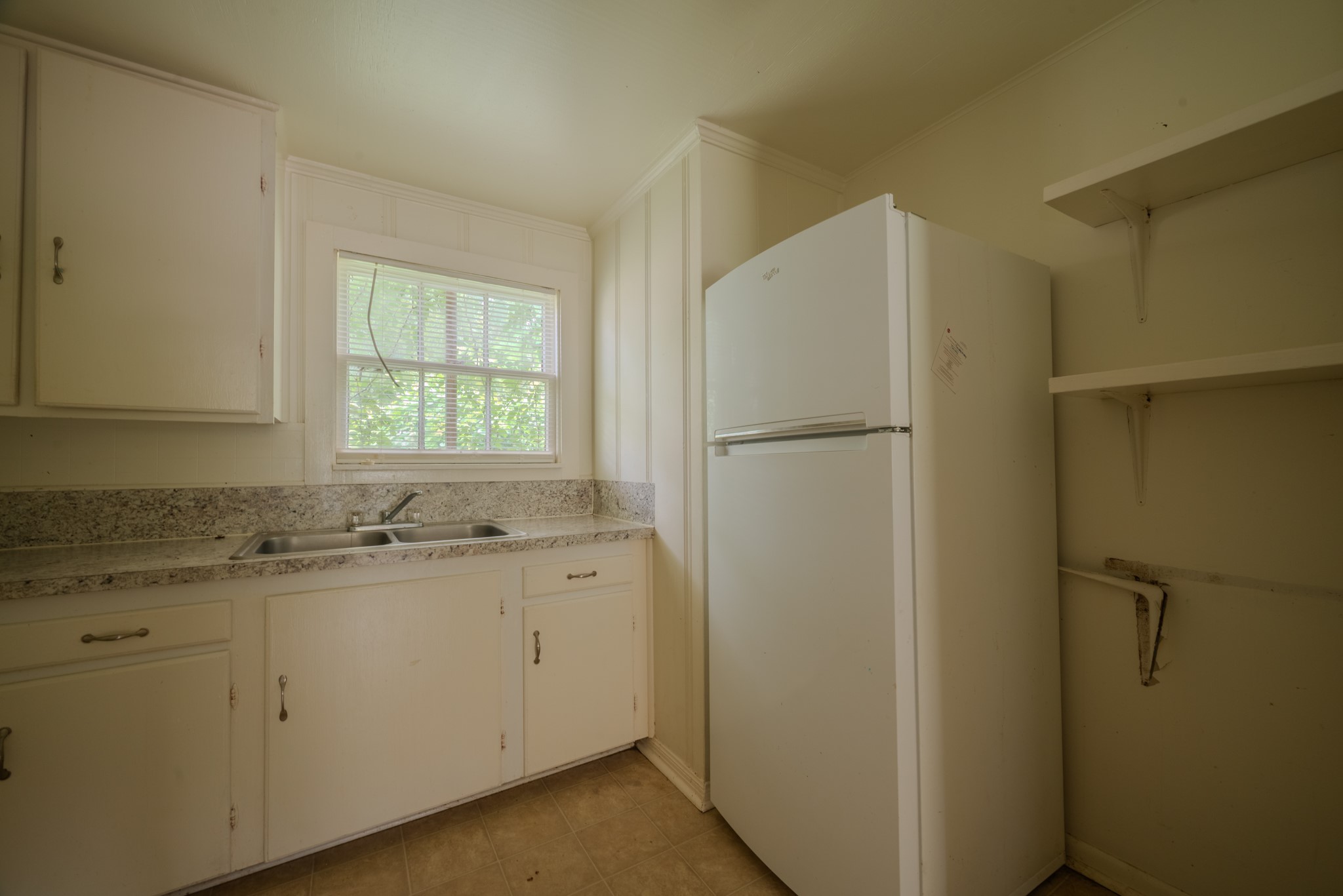 1005 Center Street Wharton, TX 77488 - Photo 13 of 33 a white refrigerator freezer sitting inside of a kitchen
