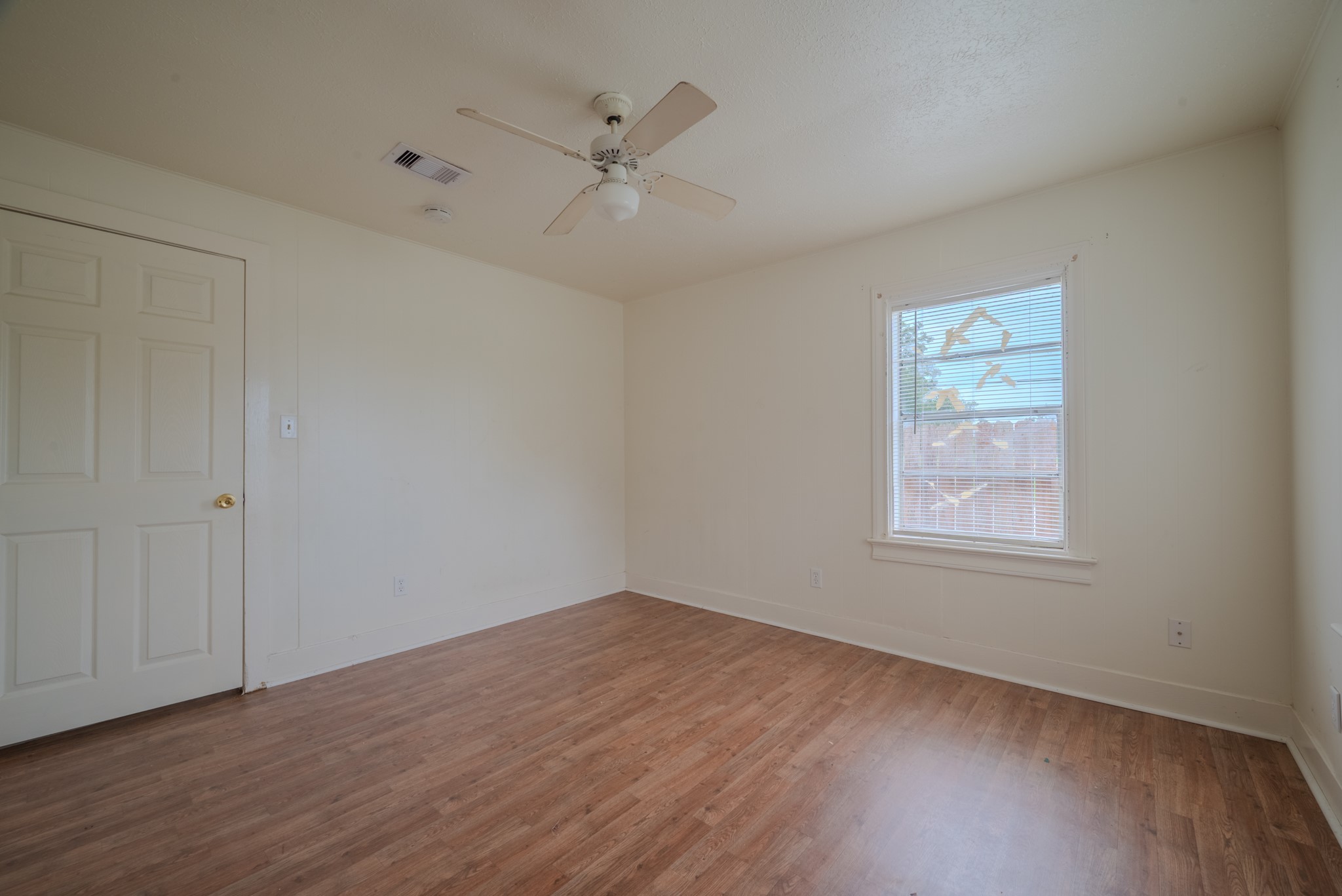 1005 Center Street Wharton, TX 77488 - Photo 27 of 33 an empty room with wooden floor closet and windows