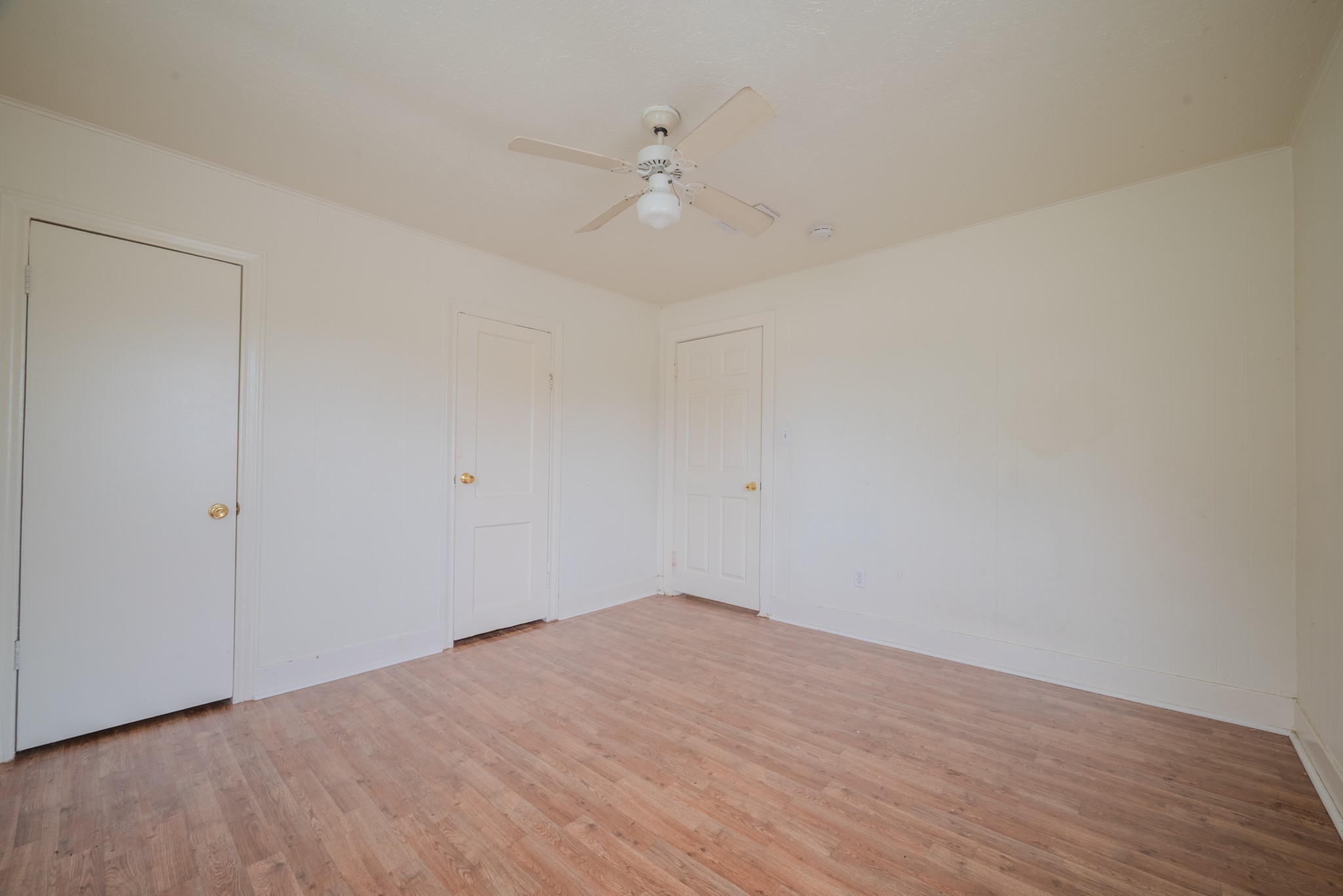 1005 Center Street Wharton, TX 77488 - Photo 28 of 33 a view of a room with wooden floor and a ceiling fan