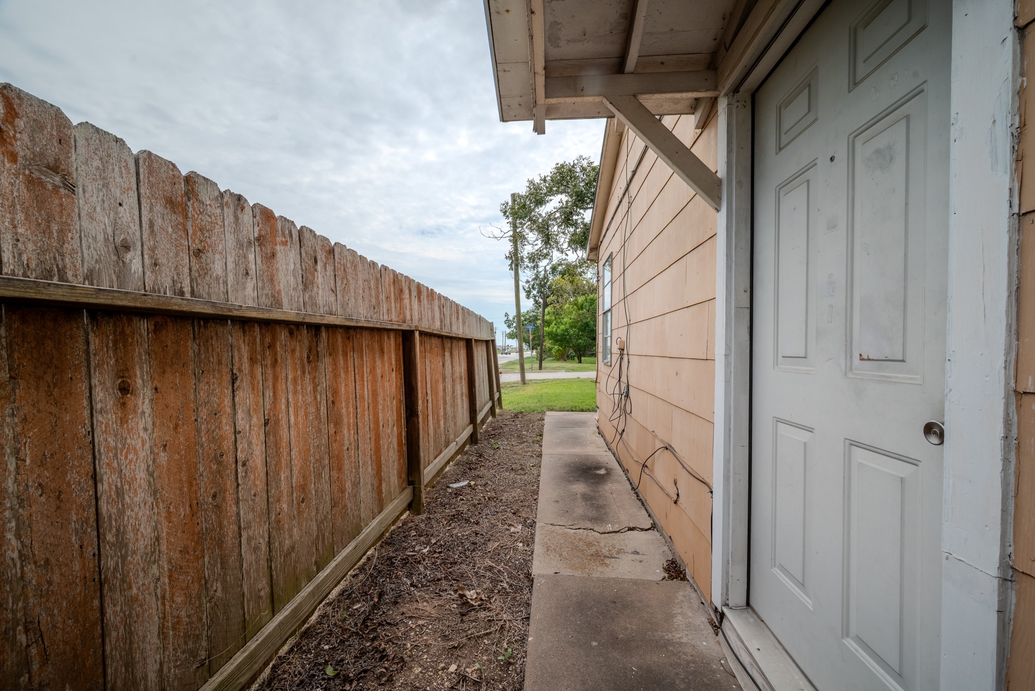 1005 Center Street Wharton, TX 77488 - Photo 32 of 33 a view of a pathway with a wooden fence