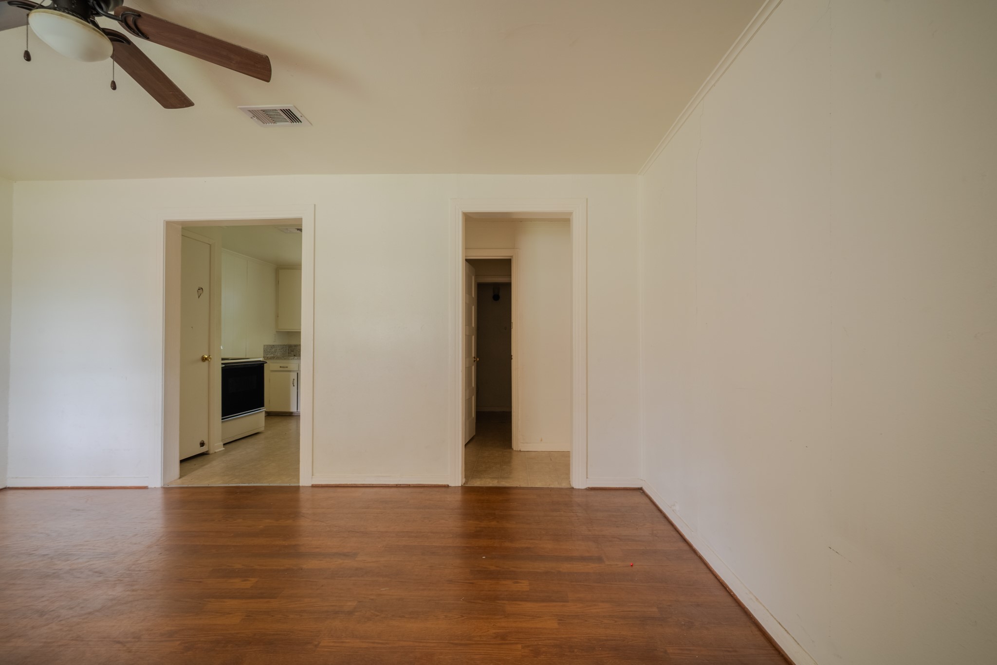 1005 Center Street Wharton, TX 77488 - Photo 7 of 33 a view of an empty room with wooden floor and a window