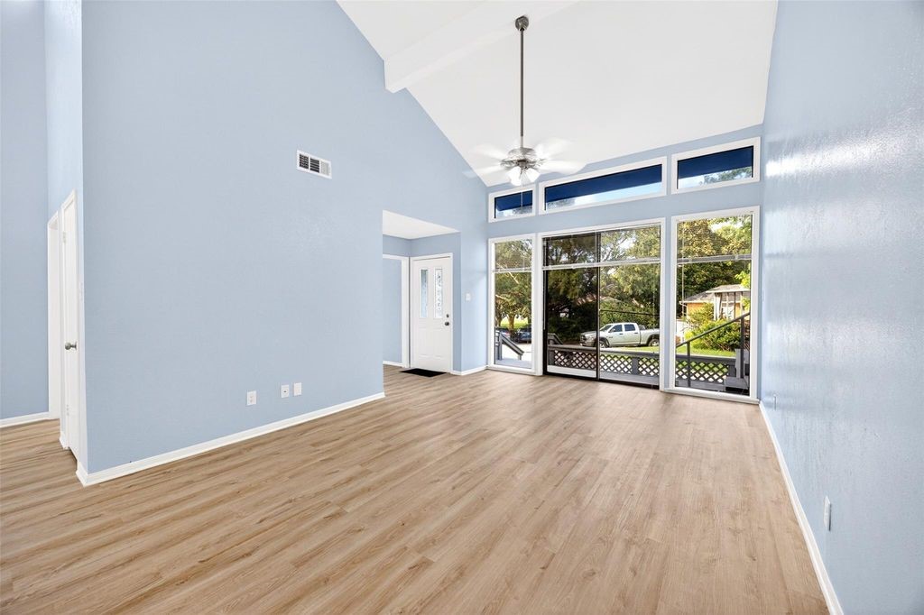 17 April Point Drive North Conroe, TX 77356 - Photo 14 of 42 a view of an empty room with wooden floor and a window