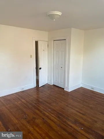 a view of an empty room and wooden floor