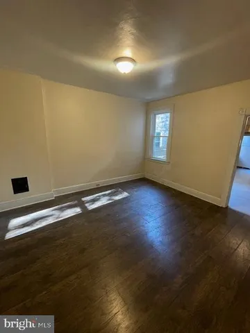 a view of room with window and wooden floor