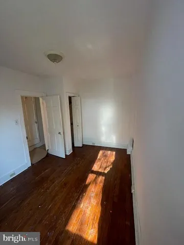 a view of an empty room and wooden floor