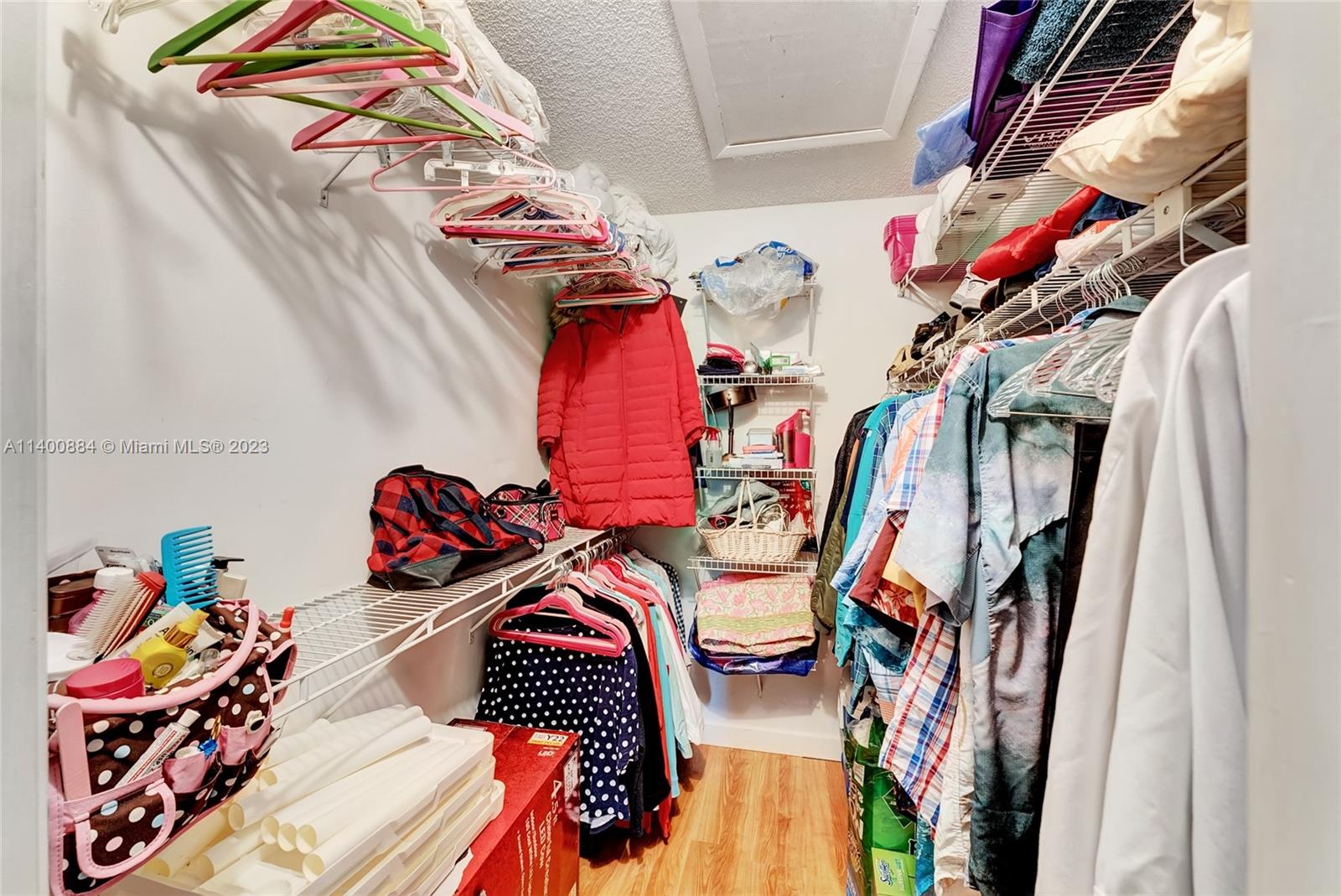 677 Trace Circle, Unit 210 Deerfield Beach, FL 33441 - Photo 13 of 21 a view of walk in closet with clothes and shoes