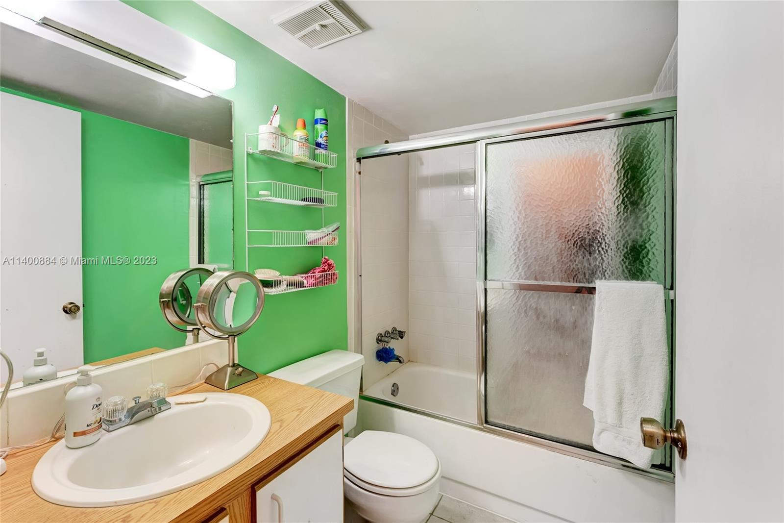 677 Trace Circle, Unit 210 Deerfield Beach, FL 33441 - Photo 16 of 21 a bathroom with a sink toilet and shower
