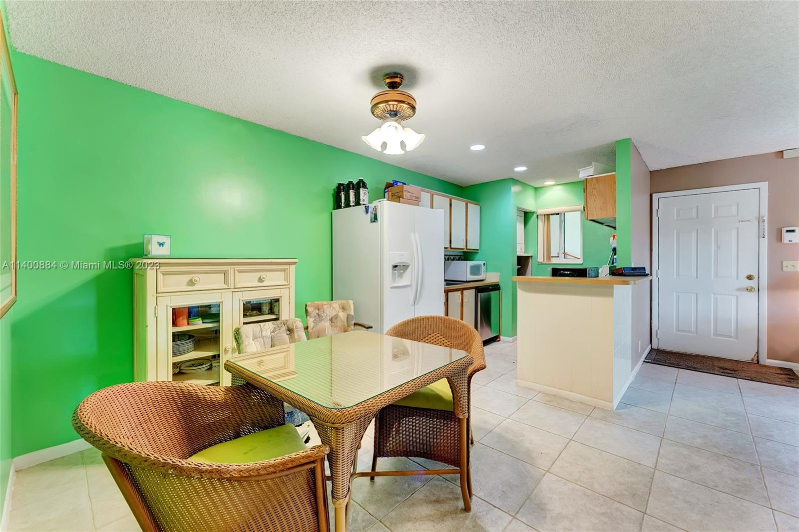 677 Trace Circle, Unit 210 Deerfield Beach, FL 33441 - Photo 3 of 21 a living room with furniture and a dining table