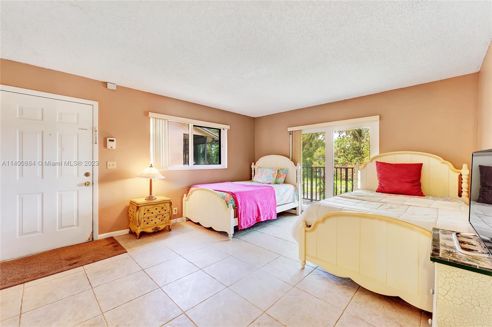 677 Trace Circle, Unit 210 Deerfield Beach, FL 33441 - Photo 8 of 21 a spacious bedroom with a bed and window