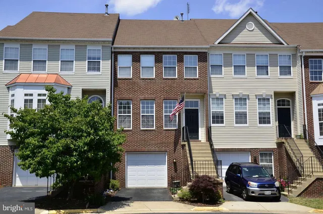 a front view of a house with plants