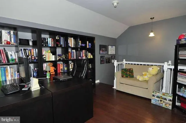 a living room with lots of furniture and wooden floor