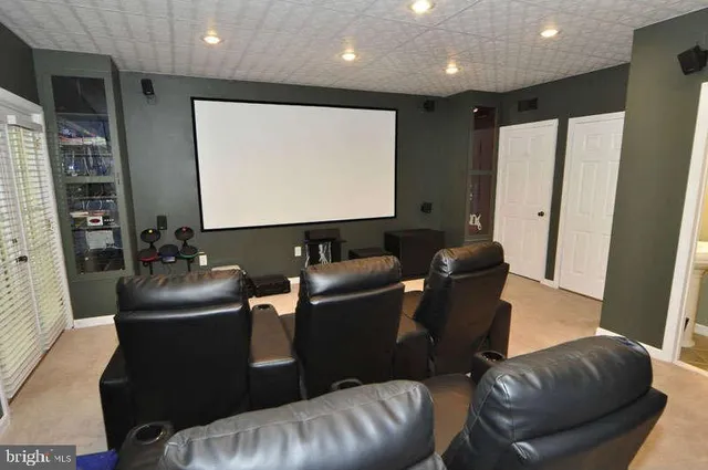 a living room with furniture and a projector screen
