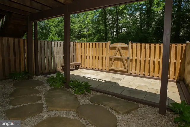 a view of a backyard with a wooden fence