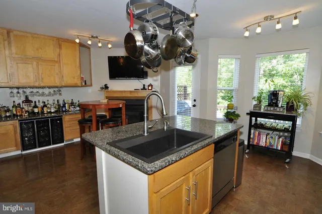 a kitchen that has a sink and a stove in it