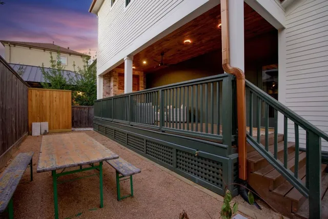 a view of balcony with wooden floor and wooden fence