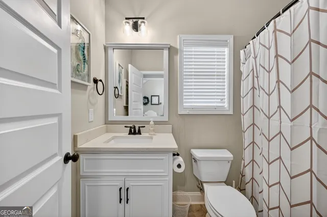a bathroom with a sink toilet and mirror