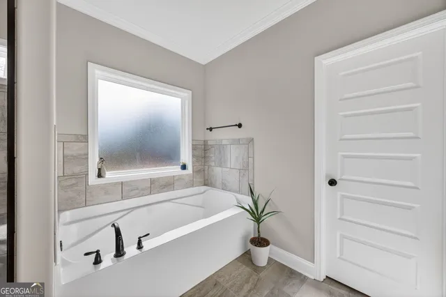 a bathroom with a bathtub and a shower