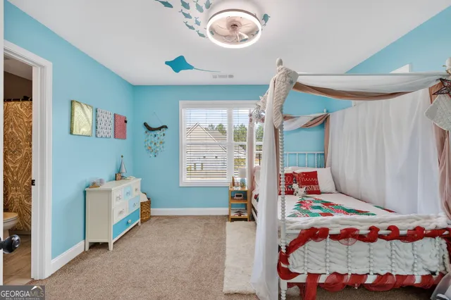 a bedroom with bed and a window