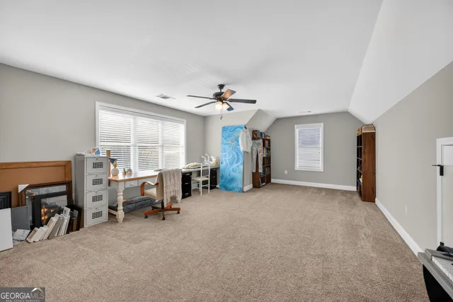 a view of a livingroom with workspace and a window