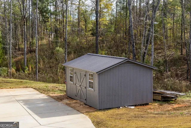 a yellow house sitting in middle of a yard