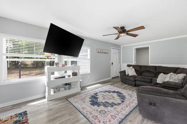 a living room with furniture and a flat screen tv