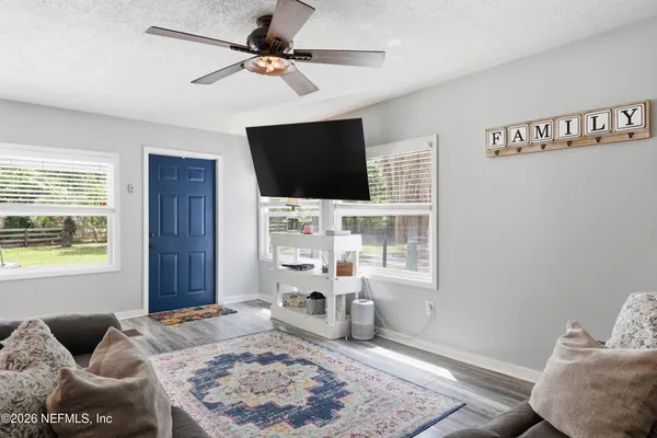 a living room with furniture and a flat screen tv