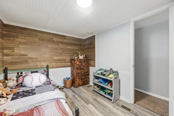 a bedroom with a bed and a book shelf