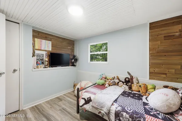a bedroom with bed and a window