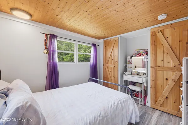 a bedroom with a large bed and a window