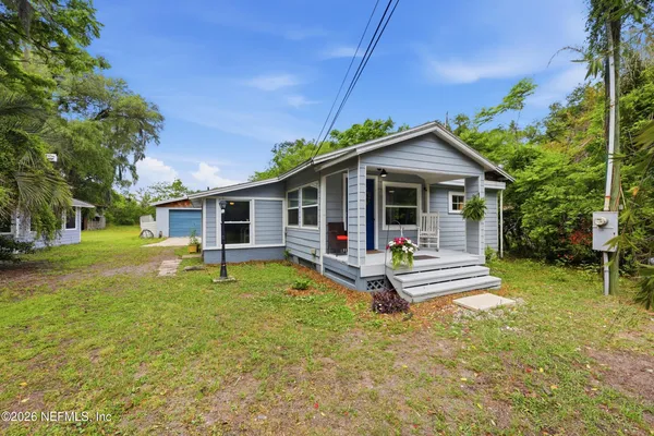 a view of a house with a yard porch and sitting area