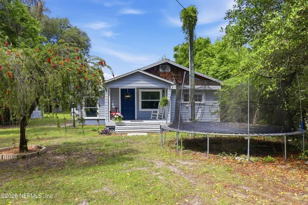 a view of a house with backyard porch and sitting area