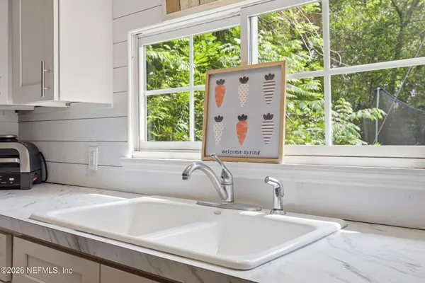a bathroom with a sink and a window