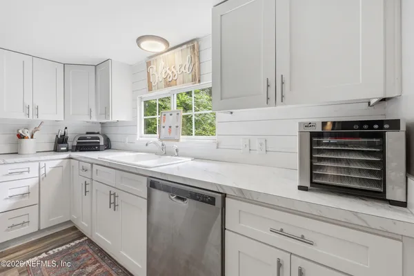 a kitchen with appliances cabinets and a sink