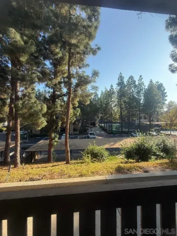 a view of a yard with wooden fence
