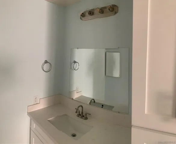 a bathroom with a sink and mirror