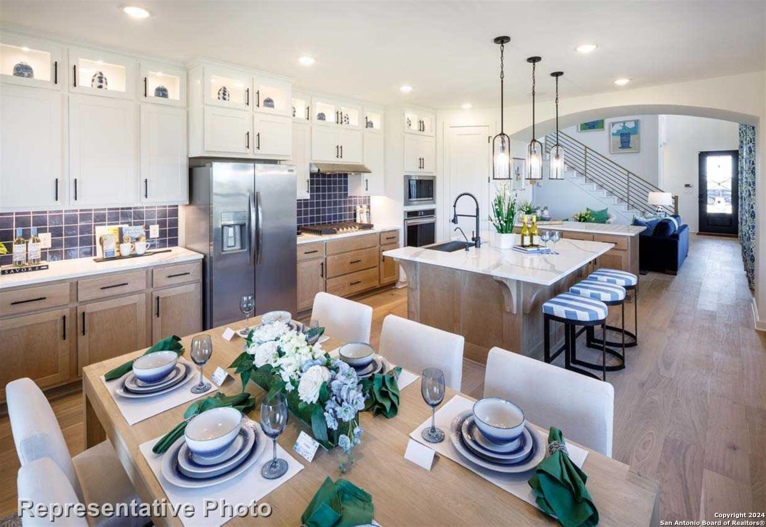a kitchen with stainless steel appliances kitchen island granite countertop a dining table and chairs