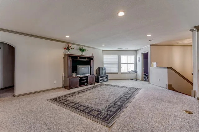 a living room with furniture flat screen tv and pool table