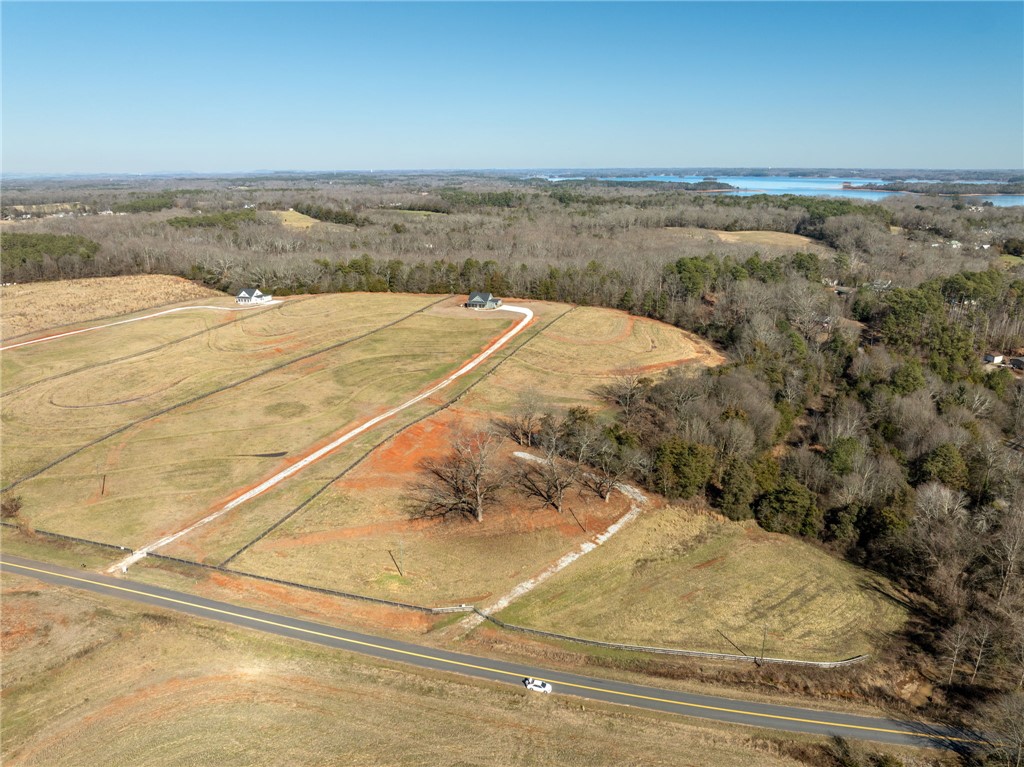 367 Dobbins Road Townville, SC 29689 - Photo 11 of 16 Expansive landscape with serene lake views and a clear, open sky.