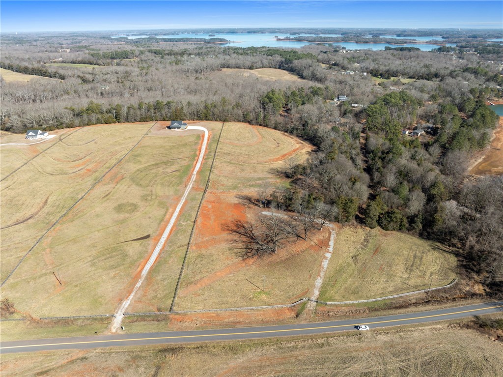 367 Dobbins Road Townville, SC 29689 - Photo 2 of 16 This elevated view captures expansive rural land, offering clear vistas of distant water features and surrounding natural beauty.