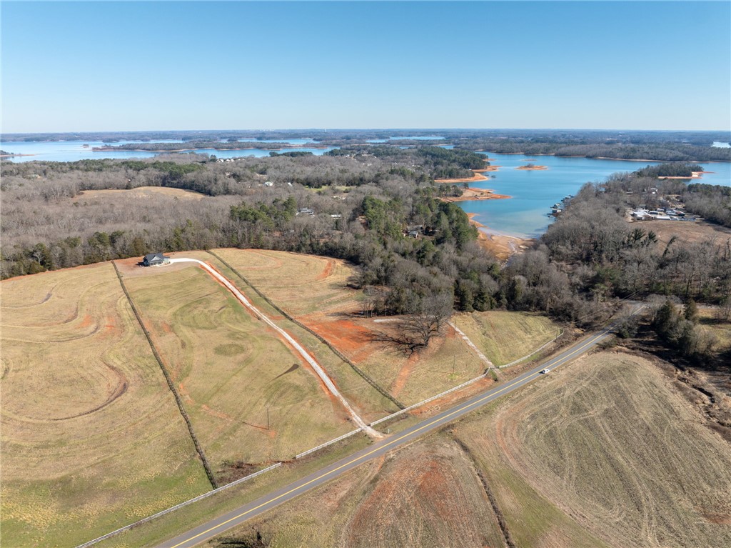 367 Dobbins Road Townville, SC 29689 - Photo 4 of 16 This aerial view showcases a peaceful lakefront property, surrounded by expansive land and natural beauty.