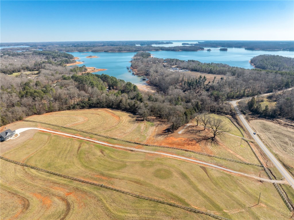 367 Dobbins Road Townville, SC 29689 - Photo 6 of 16 Scenic aerial view reveals a vast lot near the tranquil waters of a lake, framed by lush woodlands.