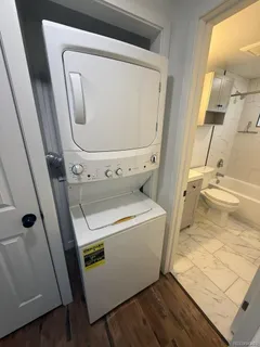 a bathroom with a granite countertop toilet sink and mirror