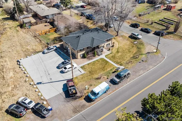 a kitchen with kitchen island a wooden floor and white cabinets