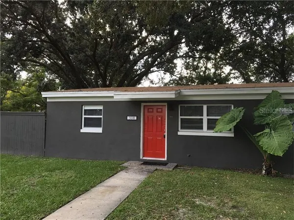 a view of house with a yard