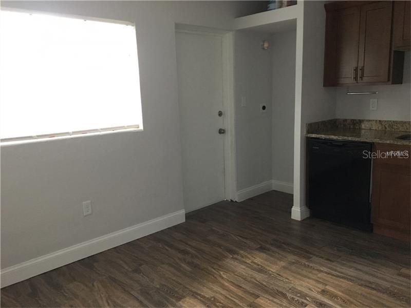 508 Varsity Street Winter Garden, FL 34787 - Photo 2 of 10 a view of an empty room with wooden floor and a window